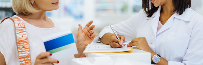 Pharmacist sending patient with a note to see a doctor